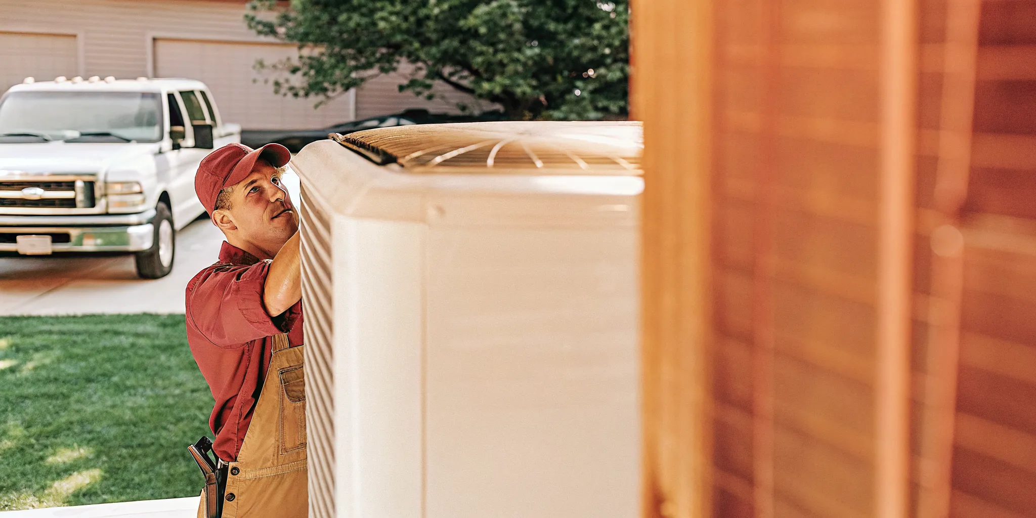 HVAC technician performing AC repair on outdoor condenser unit in San Antonio residential neighborhood